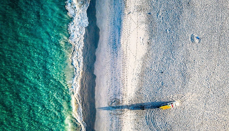 Aerial view of Leighton beach showing sand and waves